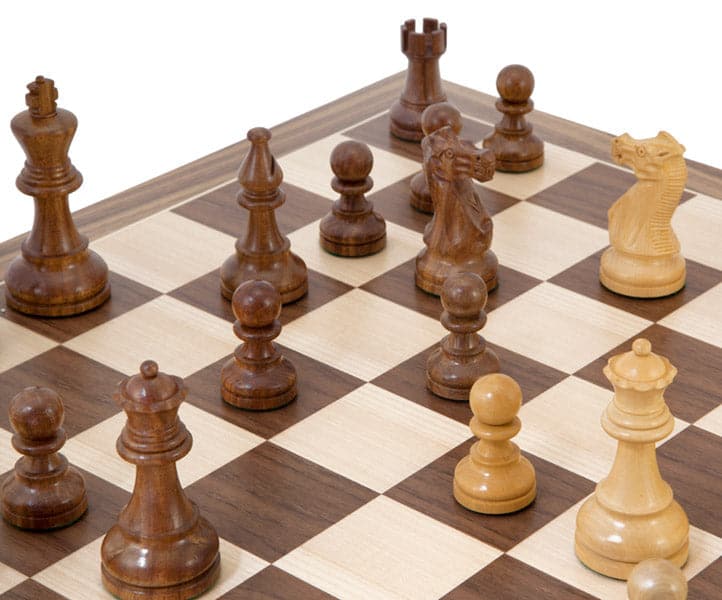 American Sheesham and Walnut Chess Set with intricately detailed Staunton chess pieces on a walnut and maple chess board.