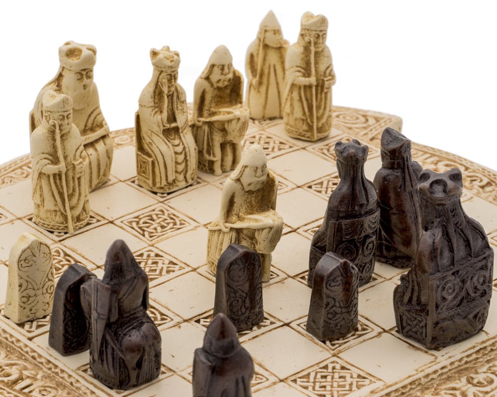 Isle of Lewis compact Celtic chess set with iconic ivory and dark chessmen on decorative stoneware board.