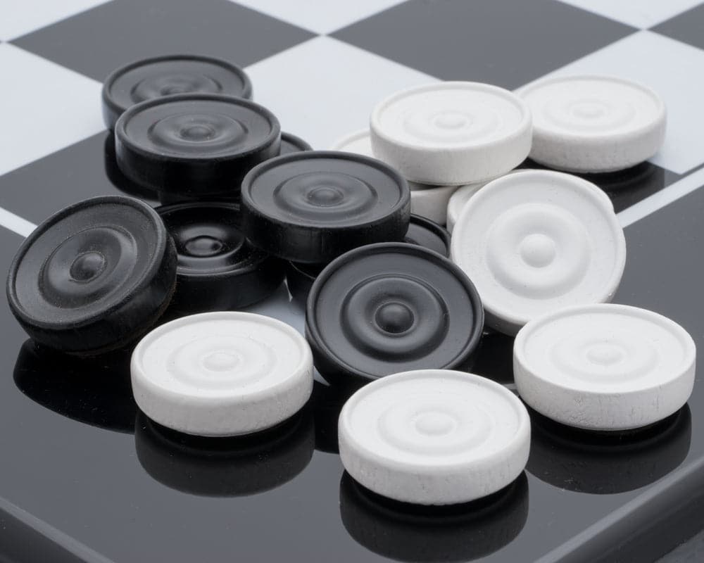 Italian lacquered wooden checkers set with black and white pieces on a checkerboard