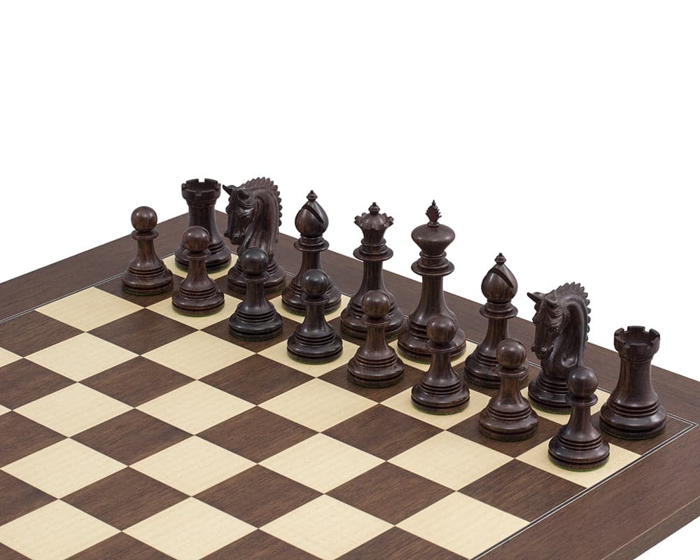 Rosewood chessmen set displayed on a chessboard with ornate detail and 4.25 inch king. Ideal for luxury gameplay.