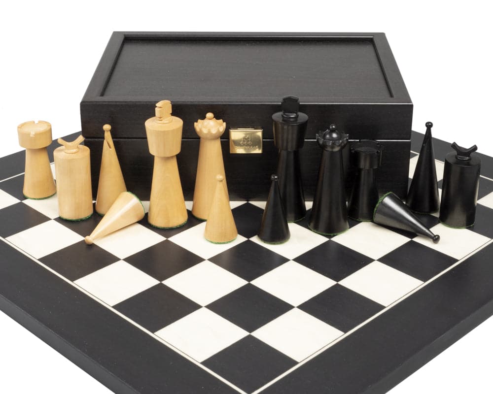 Art Deco ebonised and boxwood chess pieces 3.5 inch on chessboard with black storage box in the background.