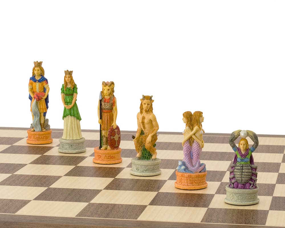 Hand-painted Zodiac chess pieces on a wooden chessboard, featuring detailed Leo and Aquarius kings, made by Italfama.