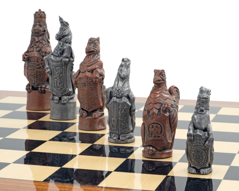 Close-up of metal and palisander Royal Beasts chess pieces set on a chessboard.