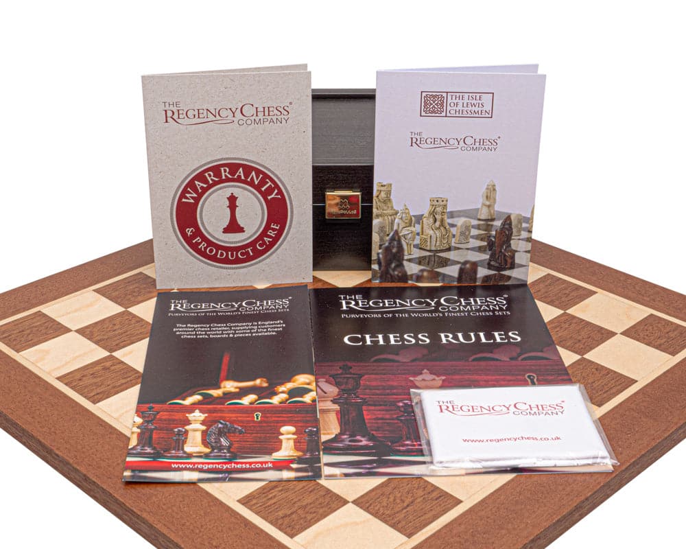 Regency Isle of Lewis and Mahogany Chess Set with warranty, chess rules, and product care guides on chessboard.