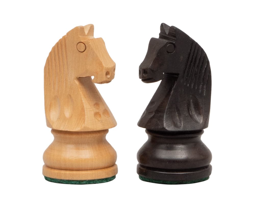 Traditional Staunton design wooden chess knights in boxwood and ebonised boxwood with felted bases.