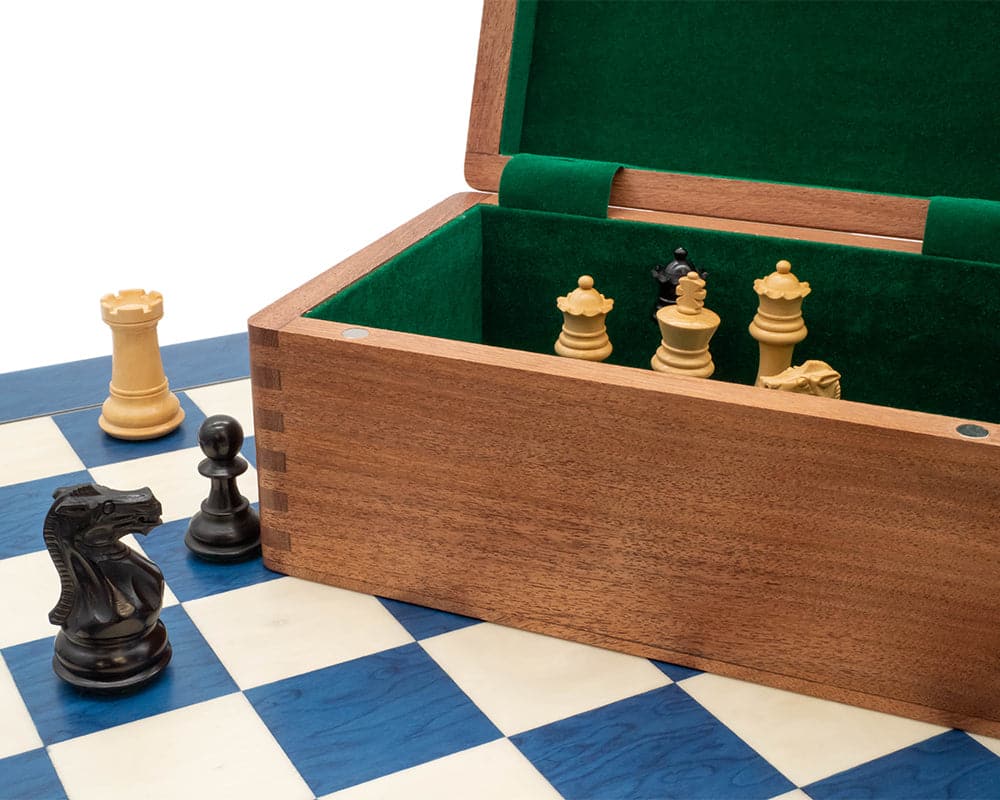 Blue and black tournament chess set with wooden case and chess pieces on blue and white checkered board.